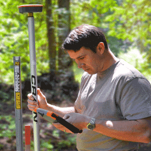 man in the forest using a GNSS receiver