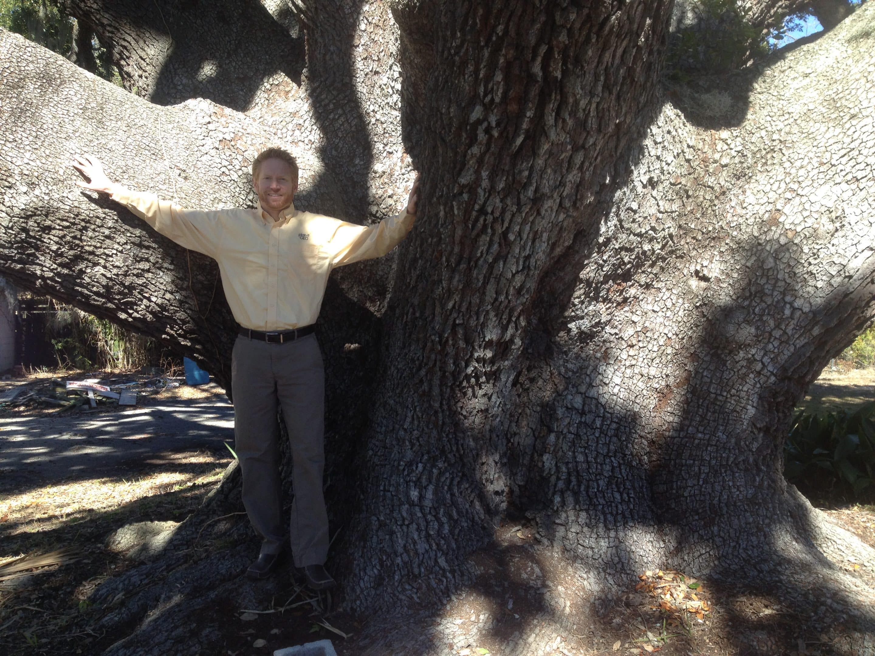 Ian Hanou standing with the biggest live oak he has ever seen.
